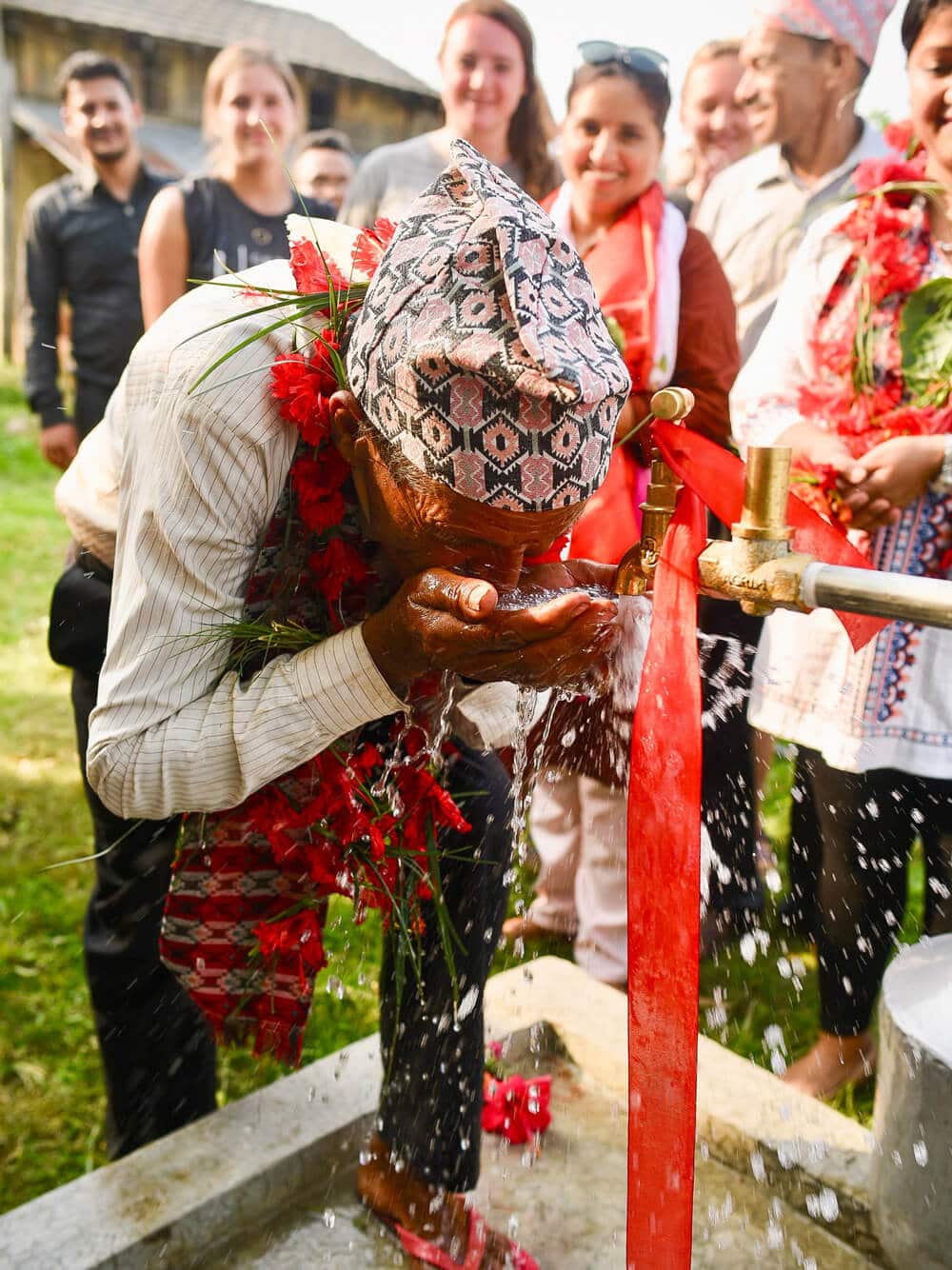 Nepalese man at water tap