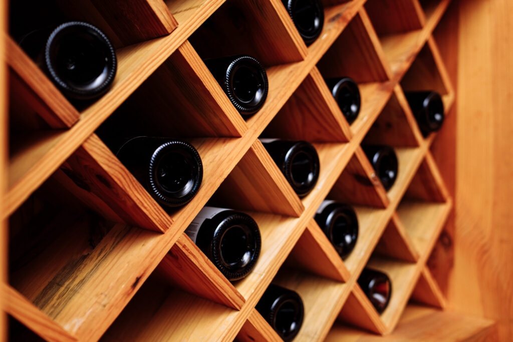 wine-bottles-stacked-on-wooden-racks-vintage-effe-2026-03-10-03-13-44-utc